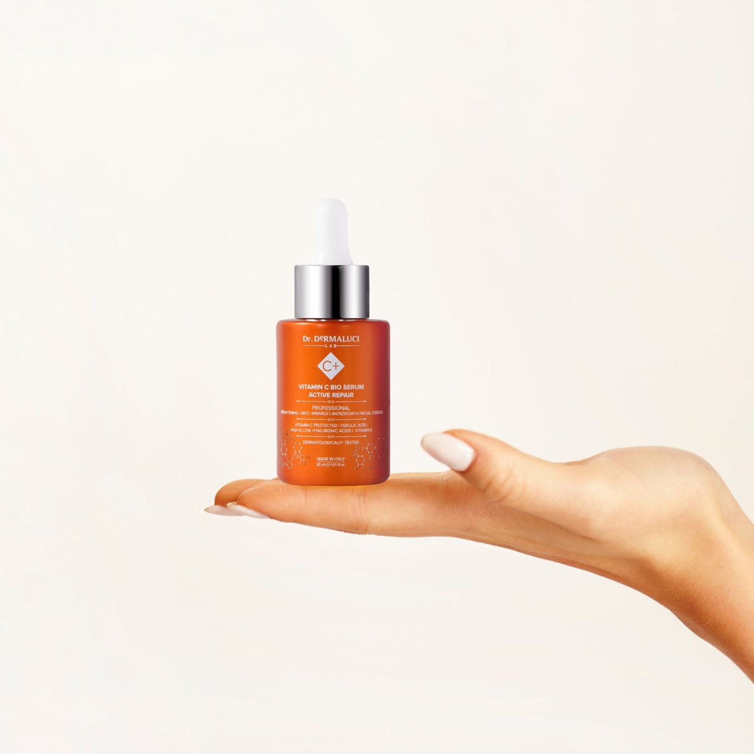 vitamin c serum bottle held in woman's hand antioxidant skincare
